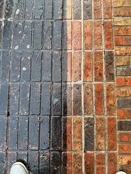 Brick patio half cleaned showing dramatic before and after